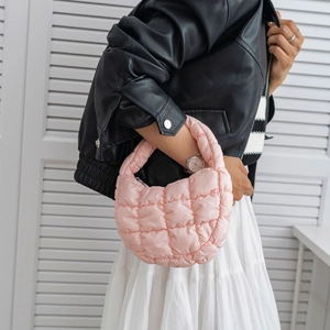 Pink quilted cloud shoulder bag for women styled on model with a casual fashion look