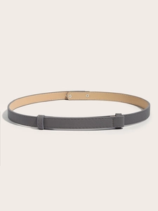 Detail showing grey cross-grain faux leather slim belt with adjustable buckle mechanism