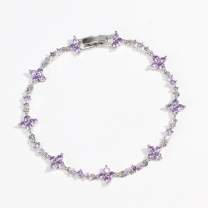Detailed view of silver flower bracelet featuring purple zircon petals and metal clasp