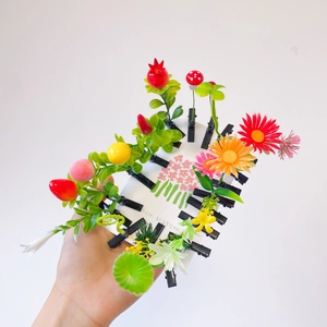 Detail view of assorted creative plant hair clips featuring colorful 3D resin fruits and flowers