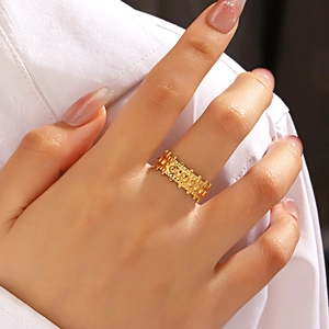 Irregular vintage beaded texture stainless steel ring in gold finish on female model