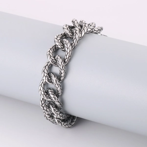 Close-up of retro punk style silver woven titanium steel bracelet for men on display