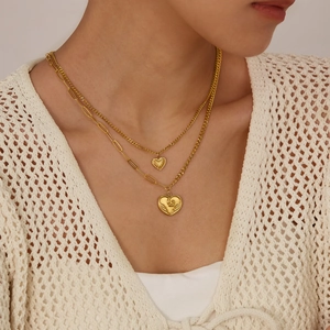French style double-layer gold heart pendant necklace worn on a female model