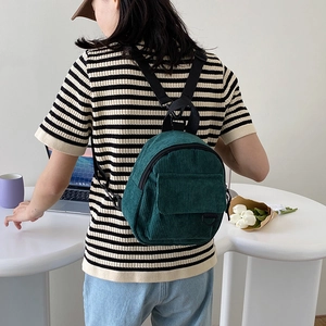 Green corduroy backpack for women featuring a minimalist vintage design and adjustable straps