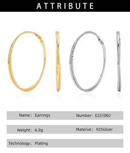 Detail showing wavy texture and silver hallmarks on gold and silver hoop earrings
