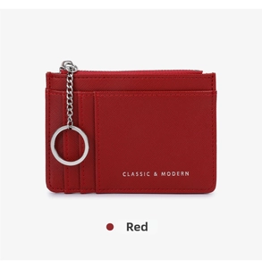 Detail of red cross-grain leather coin purse with card slots and metal keychain