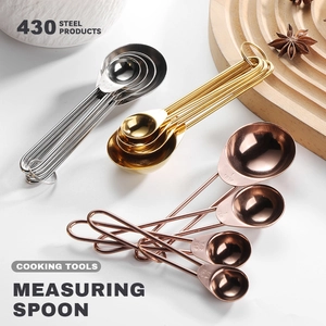 8-piece rose gold stainless steel measuring cups and spoons set on wooden tray