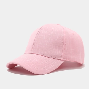 Detailed view of pink baseball cap with cross-texture fabric and six-panel structure