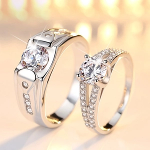 Macro shot of couple rings featuring a diamond-set wide band and a solitaire lady ring
