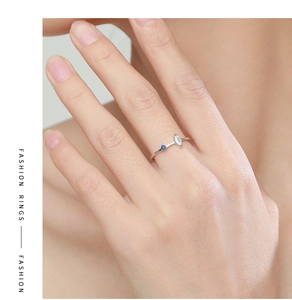 Detailed view of S925 silver ring with marquise crystal and blue stone on finger