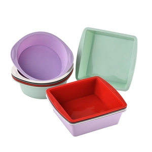 Colorful square and round silicone cake molds stacked on a clean white background