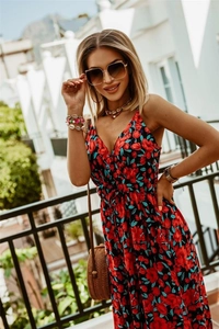 Close-up of red and blue floral print V-neck dress with bohemian shell necklace and bag
