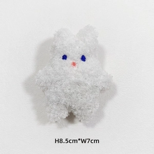 Detail of a plush white bunny charm with lamb wool texture, size 8.5cm by 7cm
