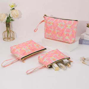Three-piece set of pink tie-dye sequin cosmetic bags with golden zippers and wrist straps