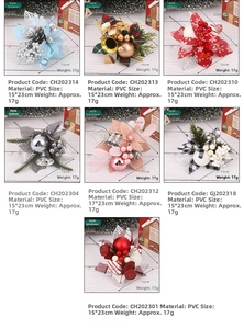 Detail of assorted PVC Christmas floral picks with red berries, pine cones and festive ribbons
