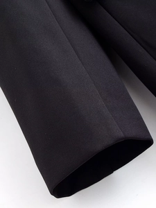 Detailed macro view of the premium high-density fabric and sewing on black dress cuffs