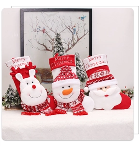 Detailed view of three knitted Christmas stockings featuring reindeer, snowman, and Santa motifs