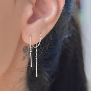 Macro view of S925 sterling silver tassel earrings with delicate double-hole chain design