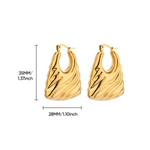 Macro detail of gold-plated chunky teardrop earrings with radial ribbed texture
