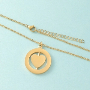 Close-up of gold stainless steel necklace with a rotatable heart circle pendant detail