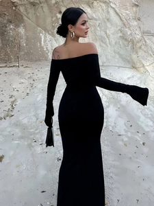 Detail of off-the-shoulder long sleeve black slim fit maxi dress with backless design