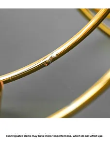 Detail of gold metal plating showing minor craft variations on a Nordic candle holder