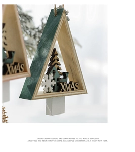 Close-up of wooden triangle Christmas tree hanger with XMAS cutout and rustic finish