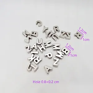 Macro shot of silver letter beads with dimensions 1.2x1cm and hole size detail