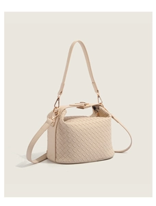 Detail of the high-quality PU leather woven texture and golden clasp on beige bag