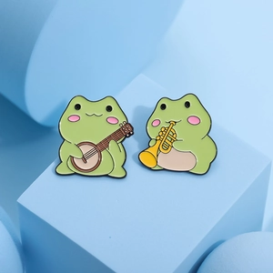 Cute green enamel frog pins playing banjo and trumpet set for clothes and bags