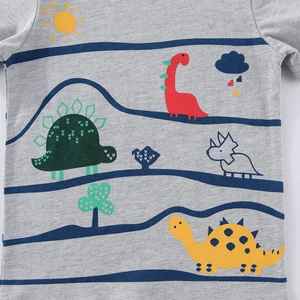 Kids grey t-shirt featuring colorful cartoon dinosaur prints and blue wave patterns