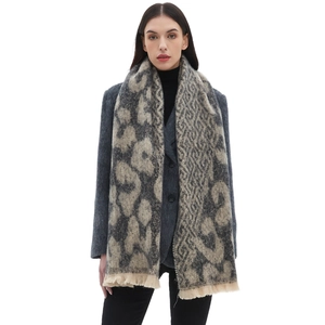 Women's leopard jacquard scarf with short tassels shown on a model in gray and beige