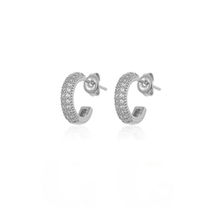 Macro detail of silver C-shaped hoop earrings with pave-set shimmering cubic zirconia
