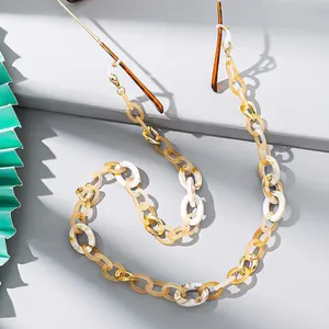 Detail of colorful acrylic eyeglass chain with tortoiseshell patterns and golden clasps