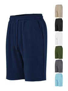 Close-up of waffle knit texture on men's casual shorts with elastic drawstring waistband