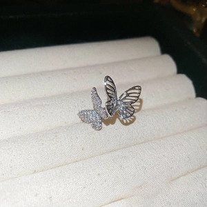 Elegant silver butterfly ear cuff with sparkling zircon inlay on velvet display