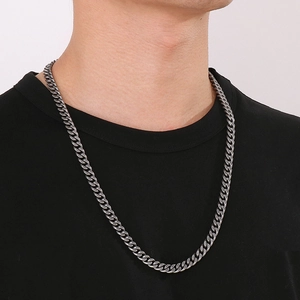Close-up of vintage distressed dark silver cuban chain necklace worn by a male model