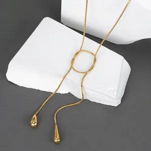 Elegant 18K gold plated stainless steel Y-necklace with teardrop pendants on white stone
