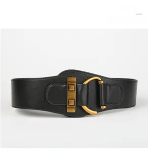 Detailed close-up of a wide black leather corset belt with vintage gold buckle and studs