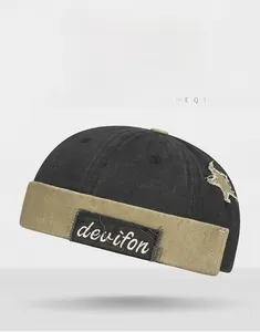 Detail of vintage patchwork docker hat showing star embroidery and washed canvas texture