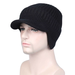 Detail of black winter knit hat featuring ear flaps and thick thermal ribbed texture