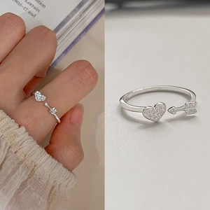 Macro shot of silver S925 heart and arrow ring with sparkling pavé cubic zirconia