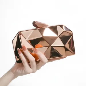 Metallic rose gold geometric evening clutch bag with faceted design and top prism clasp