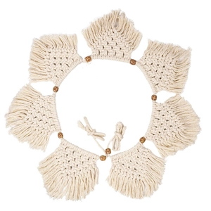 Handmade beige macrame wall hanging with wooden beads and tassels in a circular design