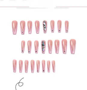Macro view of 24pcs long coffin press on nails in nude pink with V-French rhinestone accents