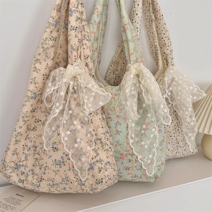 Detail of floral quilted tote bags with elegant lace bows in various colors