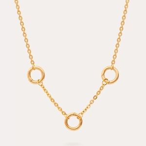 Close-up of polished 18K gold plated stainless steel rings on a delicate minimalist chain