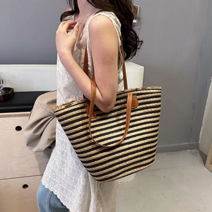 Large striped straw tote bag for beach vacations with black and brown patterns