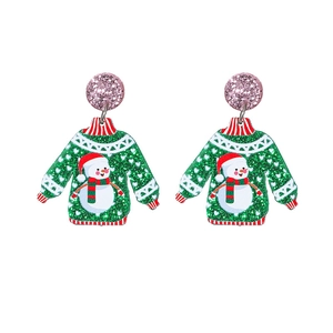 Close-up of green Christmas sweater earrings with snowman pattern and pink glitter studs