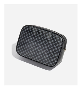 Close-up of quilted camera bag featuring grey monogram patterns and secure zipper